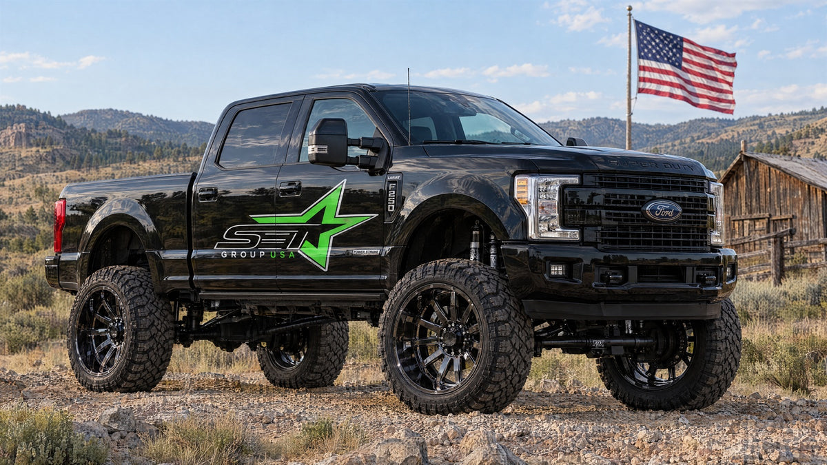 Lifted black 2019 Ford F-250 with black-chrome wheels and SET Group USA door logo beside an American flag.