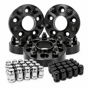 A set of black anodized wheel spacers with matching lug nuts, including silver chrome lug nuts and black lug nuts, arranged on a clean white background.
